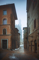 Fototapeta na wymiar Volterra old townn during a snowfall in winter. Tuscany, Italy