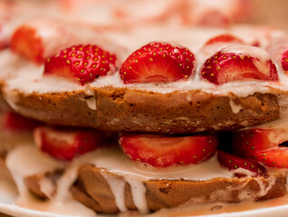 Pastries with red berries and white cream. Cake with strawberries and sour cream. Close-up. Food. Copy space. Selective focus.
