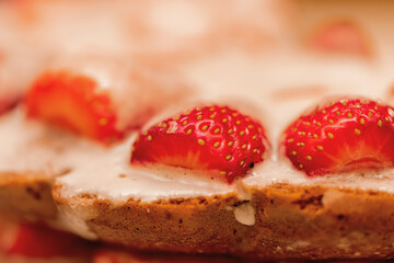Pastries with red berries and white cream. Cake with strawberries and sour cream. Close-up. Food. Copy space. Selective focus.