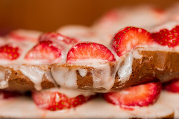 Pastries with red berries and white cream. Cake with strawberries and sour cream. Close-up. Food. Copy space. Selective focus.