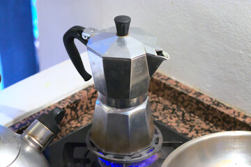 silver espresso cooker on a gas stove