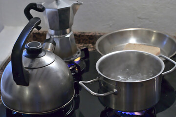 several cooking pots on gas stove