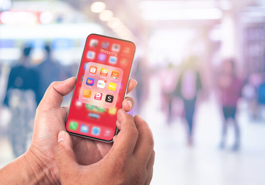 January 14, 2021, Bangkok, Thailand, people use hand holding online shopping app,Shopee,Lazada,ebay,alibaba,amazon in department store or shopping mall background blurred.