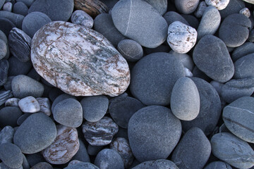 Smooth pebbles on beach in New Zealand