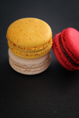 Colorful macarons isolated in black background