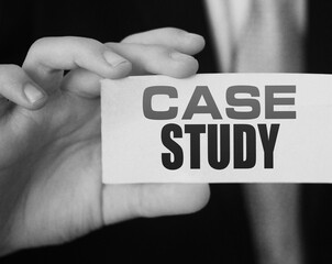 Case study, message on white card in hand of businessman