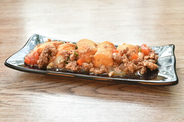 deep fried egg tofu with chop pork in sweet sauce on plate