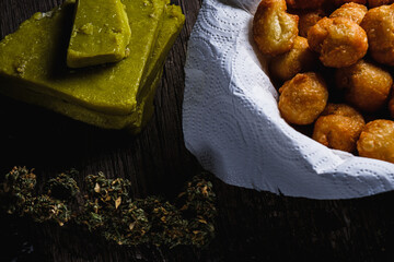 churros balls spanish donuts from medical cannabis butter, sugar, flour, egg. marijuana buds. medical cannabis butter. On a rusty baking sheet. horizontal.