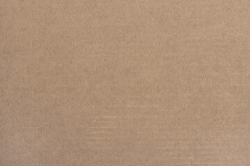 The surface structure of light brown cardboard.