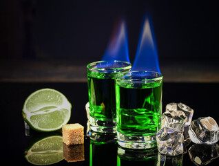 Shots of absinthe and sugar cubes isolated on black background. space for text.