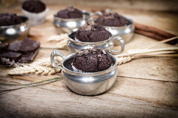 Delicious muffin, chocolate muffin in old rustic silver cup
