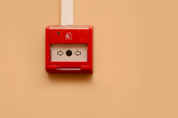 Red button alarm fire alarm on the wall. Attention evacuation people leave. Run out of outdoor