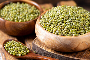 Mung. Green mung beans in a bowl on a brown wooden table. Legume plant for a healthy diet
