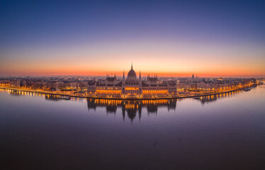 Aerial drone shot of Hungarian Parliament lights off before sunrise in Budapest dawn
