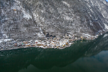 Aerial drone shot of Hallstatt village covered by snow during wi