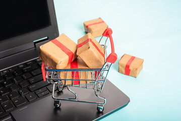  A miniature shopping cart with boxes and bags online shopping e-commerce store.