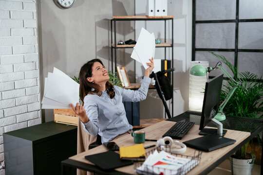 Happy businesswoman in office. Businesswoman celebrating a big accomplishment at work