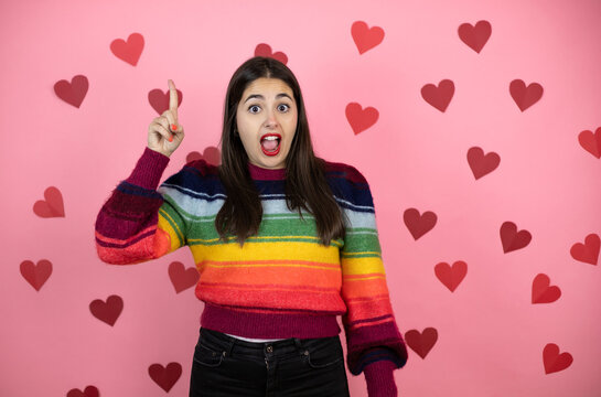 Young Beautiful Woman Over Pink Background With Harts Smiling And Thinking With Her Fingers On Her Head That She Has An Idea.