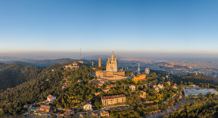 panoramic aerial drone view of Sacred Heart Basilica on top of Tibidabo near Barcelona during sunset