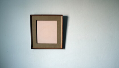 The empty old picture frame on the wall