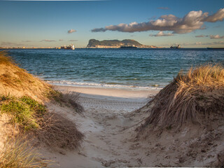 Algeciras, Rinconcillo, sand dune with sea grass and clouds with Gibraltar in the background