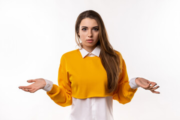Portrait of clueless and indecisive brunette girl shrugging with hands spread sideways, white...