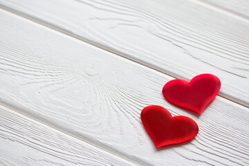 Two red hearts on a white wooden surface. Valentines Day background