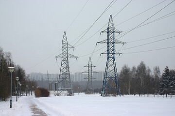 power lines on the outskirts of the city on a snowy winter day