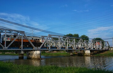 Semarang, Indonesia - 20 November 2020; The train is crossing the bridge in the west flood canal, Semarang