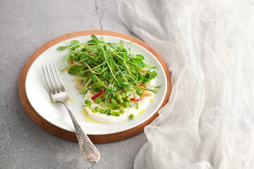  Vegan healthy salad made microgreen sprouts peas, quinoa, radish, mint and yogurt