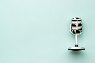 Flat lay of retro classic microphone with space for text