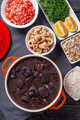 Typical Brazilian dish called Feijoada. Made with black beans, pork and sausage. Top view