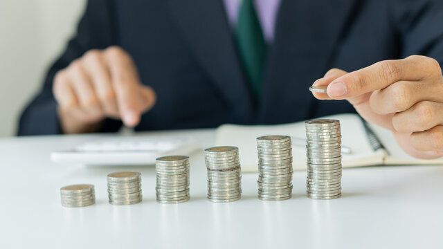 Money-saving business people hold coins for future growth and know how to manage their spending wisely.