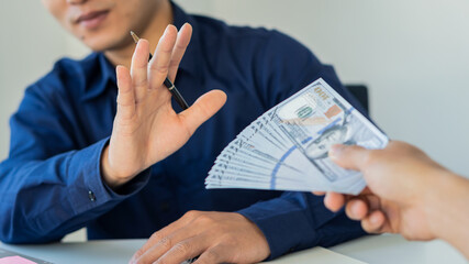 The young businessman was offered money but refused to take a bribe, showing that he was not...