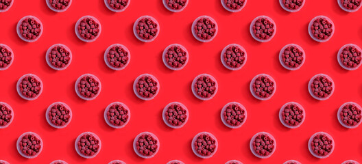 seamless pattern Berries of Frozen raspberries in a plastic container container on a red background. frozen food concept.