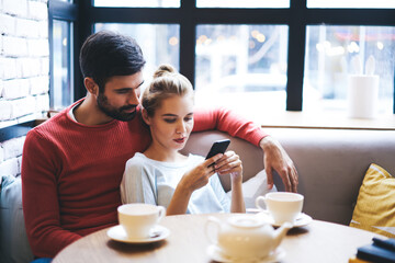 Cheerful couple chilling in cafe