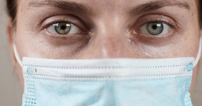 Close up female doctor wear with protective face mask in the laboratory of the clinic. COVID-19 Sars-cov-2 pandemic