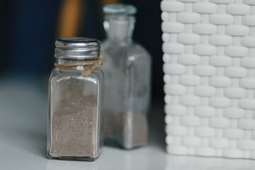 ground black pepper in glass jars