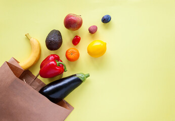 Paper bag with different products on a yellow background