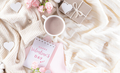 Love and Valentine's day concept, Hearts with gift box and roses, coffee cup on beige sweater or cream colour knitted blanket and fluffy background.