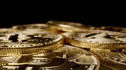 MACRO: Golden bitcoins on a black background