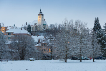 Fototapeta na wymiar Winter view at Nove Mesto nad Metuji, near Hradec Kralove, Czech republic Panorama of the city with the castle on the top of the hill, frozen trees. The centre is as Urban monument reservation. 