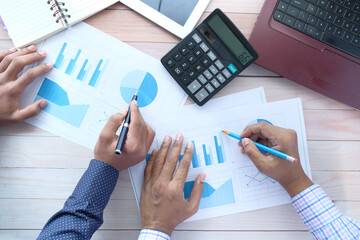 unrecognized young people analyzing bar chart on paper 