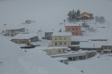 View of Castelluccio di Norcia mountain village during winter snow storm in Umbria, National Park...