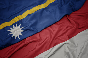 waving colorful flag of indonesia and national flag of Nauru .