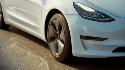 Close up view of front part of white luxury car