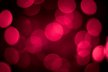 Bright pink defocus lights on a black background. Abstract bokeh background. Valentine's Day.