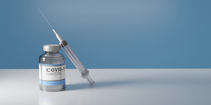 CORONAVIRUS VACCINE JAR WITH SYRINGE RESTING ON IT ON A WHITE TABLE WITH BLUE BACKGROUND