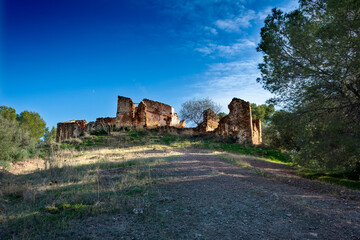 abandoned house under a blue sky with clouds