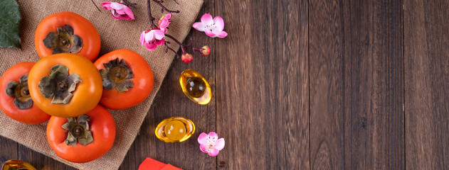 Top view of fresh persimmons on wooden table background for Chinese lunar new year
